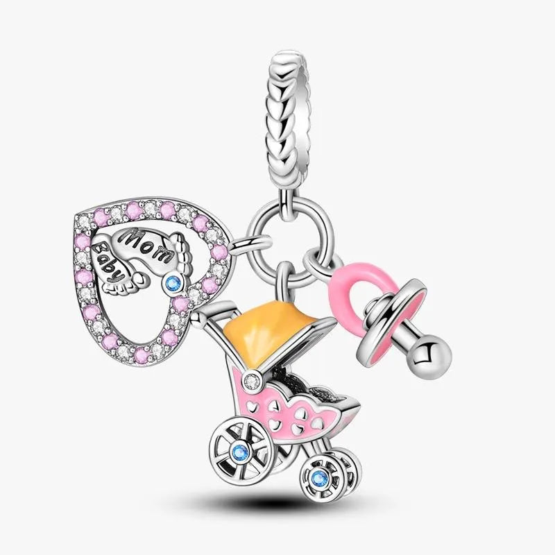 Silver charm with baby stroller, pacifier, and 'Mom and Baby' heart on a white background